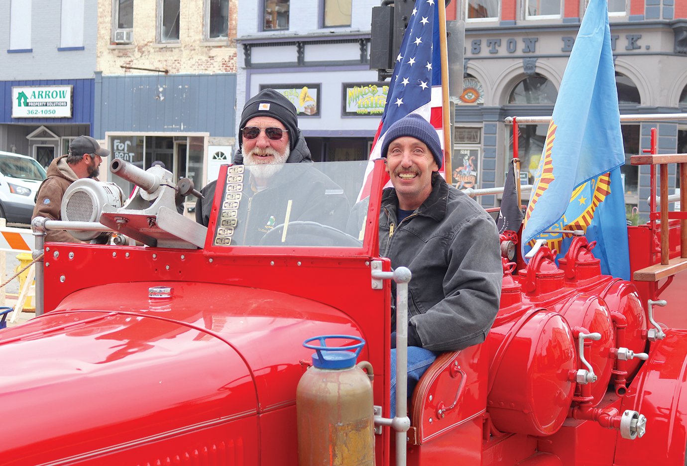 Bo Bunnell, left, and Todd Stevenson drive away in the Sons of the American Legion's Voiture 1310 following Veterans Day services at Canine Plaza Wednesday in downtown Crawfordsville.